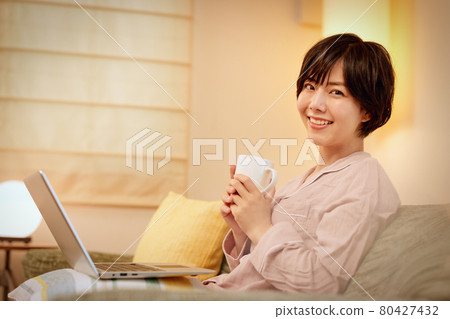 年輕女子在沙發上看電腦 年輕女子在沙發上看電腦 80427432
