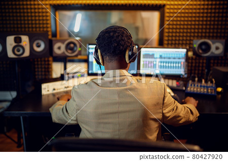 Male sound engineer at mixing consol, back view 80427920