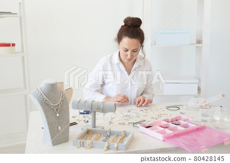 Professional accessories designer making handmade jewelry in studio workshop. Fashion, creativity and handmade concept. Professional accessories designer making handmade jewelry in studio workshop. Fashion, creativity and handmade concept. 80428145