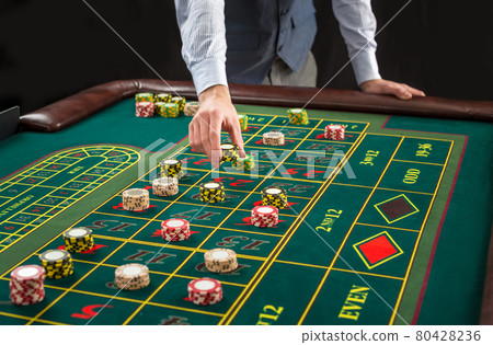 Picture of a green table and betting with chips. Picture of a green table and betting with chips. 80428236