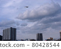 A passenger plane flying low over the city to land at Haneda Airport 80428544