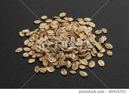 Top view of oat flakes on black background Top view of oat flakes on black background 80428701