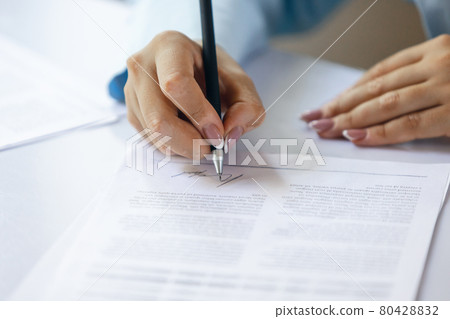 Close up of female hands signing business contract. Concept of female business, online education, professional occupation Close up of female hands signing business contract. Concept of female business, online education, professional occupation 80428832