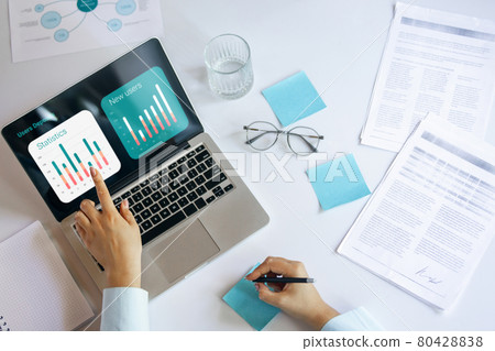 Young woman, manager working at office. Using laptop, modern gadgets. Remote working. Workplace at comapny, home with PC, devices. Young woman, manager working at office. Using laptop, modern gadgets. Remote working. Workplace at comapny, home with PC, devices. 80428838