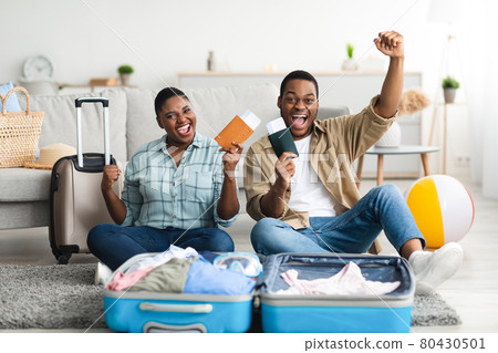 Happy Black Travelers Gesturing Yes Posing With Travel Tickets Indoors 80430501