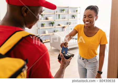 Black Female Paying With Credit Card For Delivery At Home Black Female Paying With Credit Card For Delivery At Home 80430638