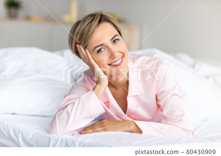 Happy mature woman posing at camera after wake up 80430909