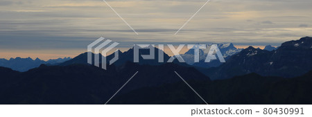 Scene seen from Mount Brienzer Rothorn on a rainy summer morning. Clouds over Mount Titlis. 80430991