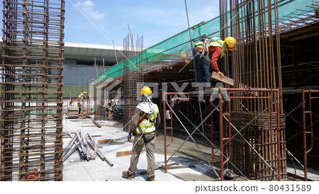 KUALA LUMPUR, MALAYSIA -JANUARY 14, 2017: Construction workers fabricating steel reinforcement bar at the construction site. The reinforcement bar was tied together using tiny wire.     80431589