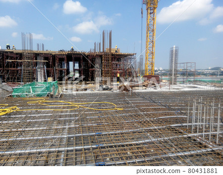 KUALA LUMPUR, MALAYSIA -NOVEMBER 23, 2020: Building floor slab under construction. Construction workers fabricating the timber formwork and installing the steel reinforcement bar. KUALA LUMPUR, MALAYSIA -NOVEMBER 23, 2020: Building floor slab under construction. Construction workers fabricating the timber formwork and installing the steel reinforcement bar. 80431881