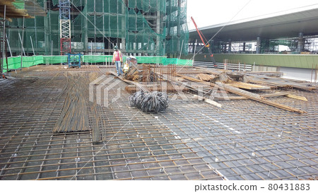 KUALA LUMPUR, MALAYSIA -NOVEMBER 23, 2020: Building floor slab under construction. Construction workers fabricating the timber formwork and installing the steel reinforcement bar. KUALA LUMPUR, MALAYSIA -NOVEMBER 23, 2020: Building floor slab under construction. Construction workers fabricating the timber formwork and installing the steel reinforcement bar. 80431883