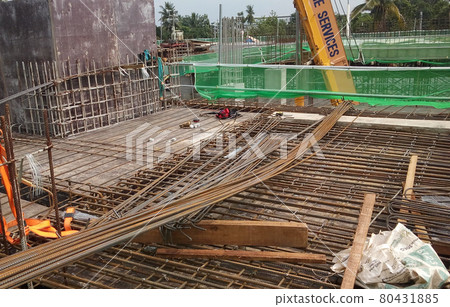 KUALA LUMPUR, MALAYSIA -NOVEMBER 23, 2020: Building floor slab under construction. Construction workers fabricating the timber formwork and installing the steel reinforcement bar.  80431885