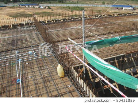 KUALA LUMPUR, MALAYSIA -NOVEMBER 23, 2020: Building floor slab under construction. Construction workers fabricating the timber formwork and installing the steel reinforcement bar. KUALA LUMPUR, MALAYSIA -NOVEMBER 23, 2020: Building floor slab under construction. Construction workers fabricating the timber formwork and installing the steel reinforcement bar. 80431889