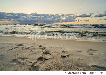 Epic dark sunset sky above the sea shore after the storm.  80432194