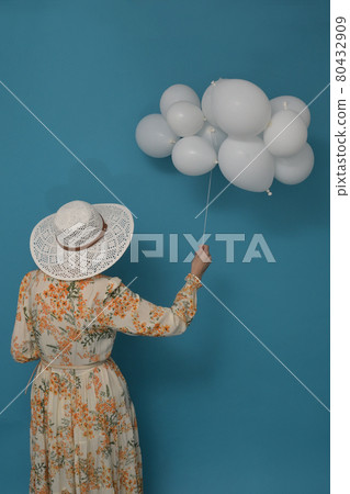 Cloudy day. Concept with woman and white baloons Cloudy day. Concept with woman and white baloons 80432909