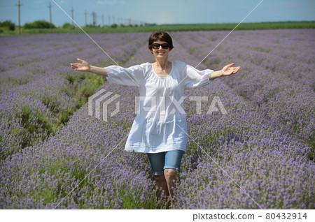 Happy Woman walking in Lavender Field Happy Woman walking in Lavender Field 80432914