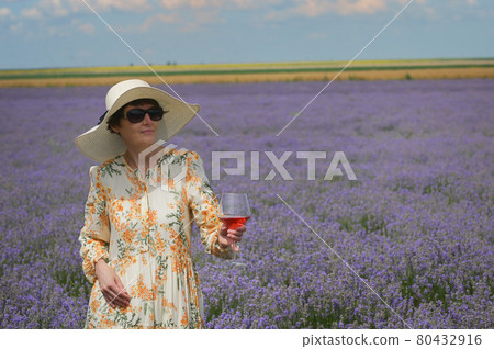 Woman with Rose Wine In Lavender Field Woman with Rose Wine In Lavender Field 80432916