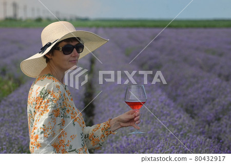 Woman with Rose Wine In Lavender Field Woman with Rose Wine In Lavender Field 80432917