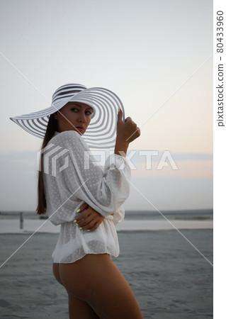 Stylish sensual woman in beachwear and hat 80433960