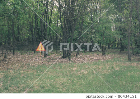 Red-yellow radiation sign on a lawn. Exclusion Zone. Chernobyl, Pripyat Red-yellow radiation sign on a lawn. Exclusion Zone. Chernobyl, Pripyat 80434151