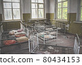 Empty Kindergarten Building. Baby cots arranged in disarray. Abandoned building in Pripyat 80434153