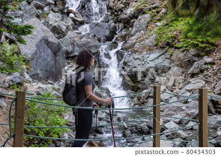 Adventurous White Caucasin Adult Woman Hiking on a trail in Canadian Nature 80434303