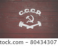 Soviet painted coat of arms. Hammer and sickle drawn on wooden boards 80434307