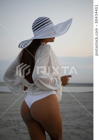 Stylish sensual woman in beachwear and hat 80434401