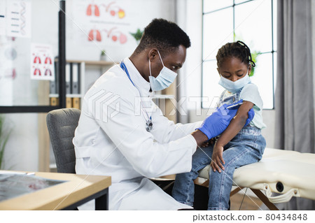 Male physician vaccinating little girl from coronavirus Male physician vaccinating little girl from coronavirus 80434848
