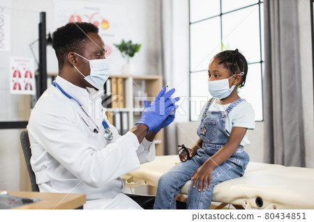 African pediatrician injecting vaccine to cute african girl African pediatrician injecting vaccine to cute african girl 80434851