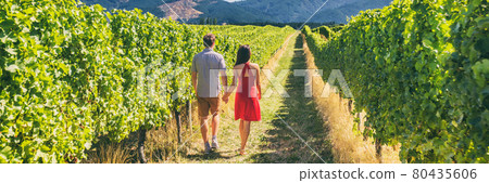 Winery vineyard tourists couple walking on wine farm tour on travel vacation. Wine tasting holiday panoramic banner. Winery vineyard tourists couple walking on wine farm tour on travel vacation. Wine tasting holiday panoramic banner. 80435606