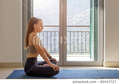 Young woman practicing deep yoga nauli breathing Young woman practicing deep yoga nauli breathing 80435727