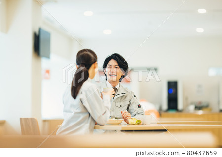 Male and female staff in work clothes eating lunch at the employee cafeteria "LINK FOREST" 80437659