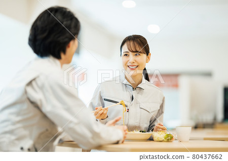 Male and female staff in work clothes eating lunch at the employee cafeteria "LINK FOREST" 80437662