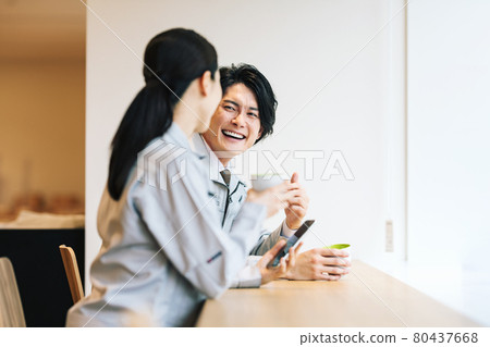 Male and female staff in work clothes taking a break in the employee cafeteria "LINK FOREST" 80437668
