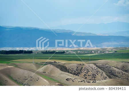 Grassland and mountains in a cloudy day. Grassland and mountains in a cloudy day. 80439411