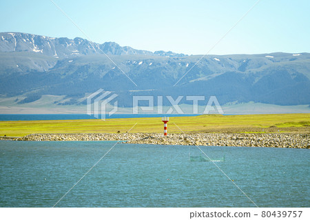 Road and lighthouses on the lake. Shot in Sayram Lake in Xinjiang, China. 80439757