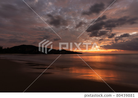 Gorgeous sunset light illuminated sea surface with a bright light, mountain in silhouette. Iriomote Island. Gorgeous sunset light illuminated sea surface with a bright light, mountain in silhouette. Iriomote Island. 80439881