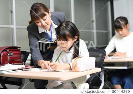 Image of elementary school girls studying during class 80444289