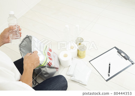 Men preparing disaster prevention goods 80444353
