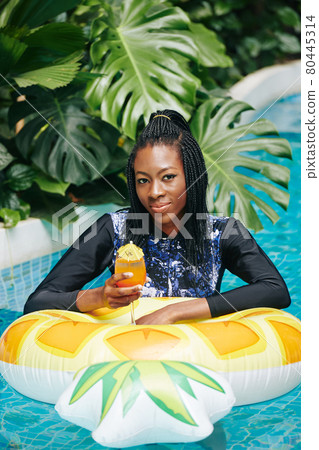 Woman in Long Sleeve Swimsuit Standing in Pool Woman in Long Sleeve Swimsuit Standing in Pool 80445314