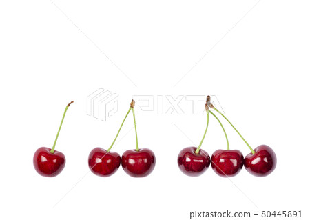 One, two and three Ripe red sweet cherry isolated on white background. Macro photo close up. One, two and three Ripe red sweet cherry isolated on white background. Macro photo close up. 80445891