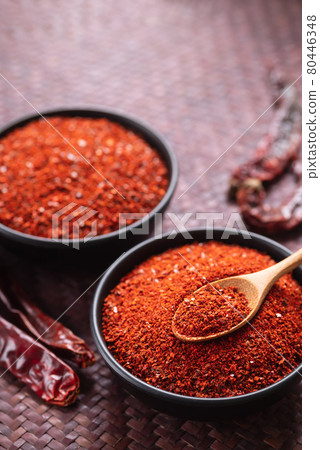 Red chili pepper powder in a bowl with spoon, Chili flakes 80446348
