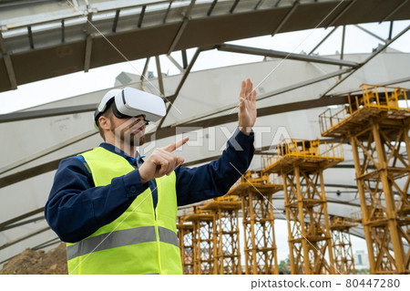 Engineer in VR glasses working on site Engineer in VR glasses working on site 80447280