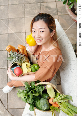 Young Woman with Bag of Groceries Young Woman with Bag of Groceries 80447418