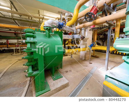 Green pressure tank connected to the piping system. Green pressure tank connected to the piping system. 80448270