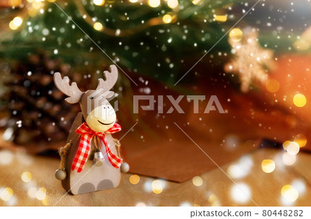 Christmas composition with holiday elk decoration.Burning lantern and christmas decoration on brown background,copy space 80448282