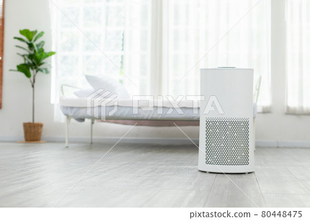 Air purifier in cozy white bedroom for filter and cleaning removing dust PM2.5 HEPA and virus in home,for fresh air and healthy Wellness life,Air Pollution Concept 80448475