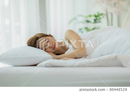 Beautiful Attractive Asian woman sleep and sweet dream lying on bed in cozy bedroom in the morning,Young girl sleep on bed relax and comfortable,Sleep and Rest Healthcare Concept Beautiful Attractive Asian woman sleep and sweet dream lying on bed in cozy bedroom in the morning,Young girl sleep on bed relax and comfortable,Sleep and Rest Healthcare Concept 80448529