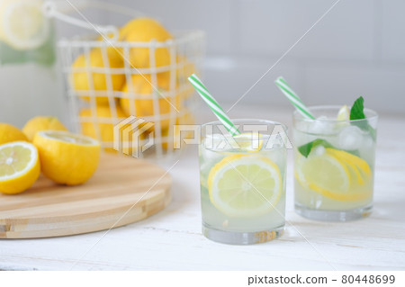 Fresh lemon lemonade with mint in bottle on kitchen table with ingredients. healthy nutrition diet concept. White background. 80448699